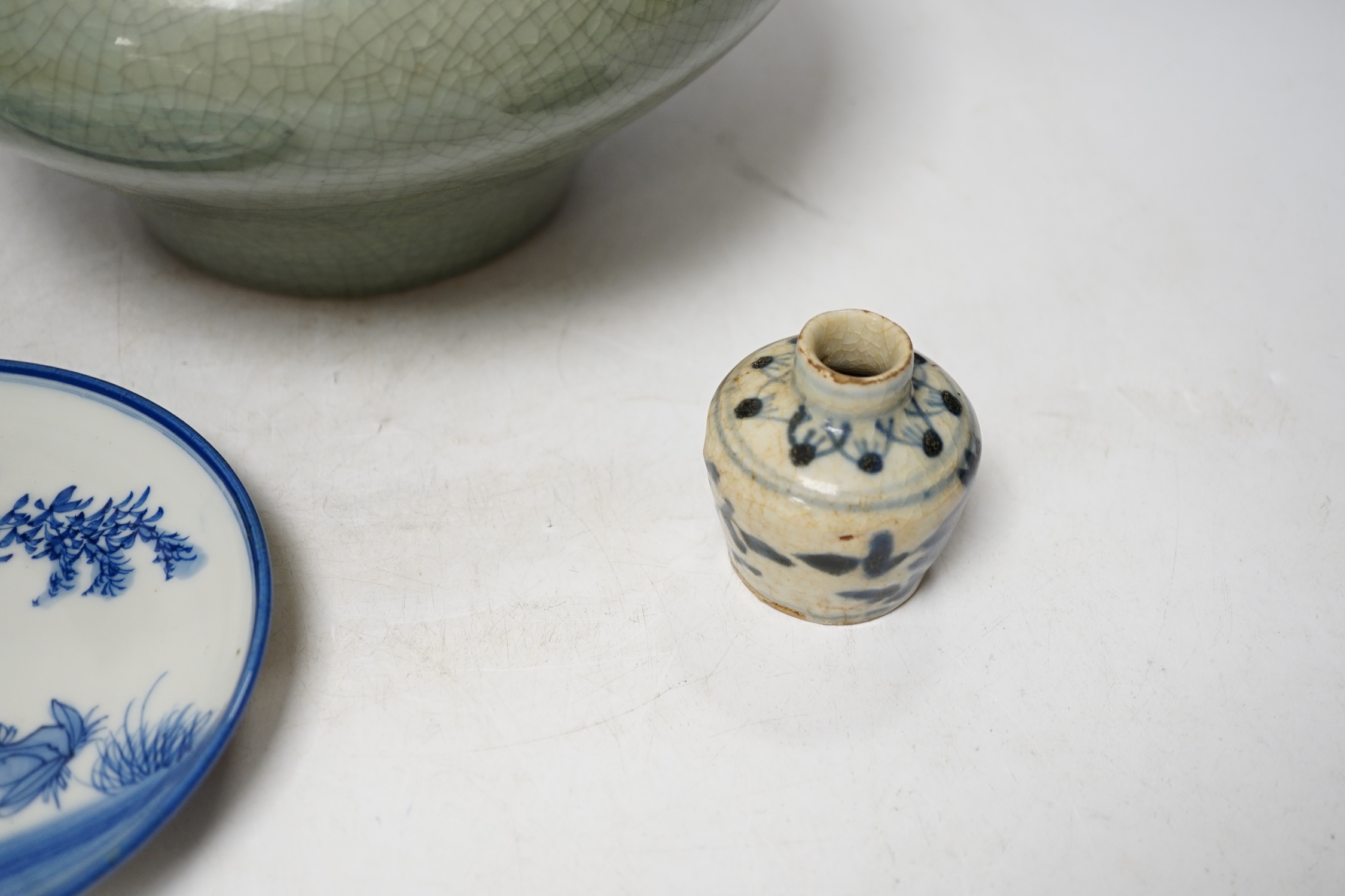 Three pieces of Asian pottery items comprising a Japanese blue and white dish, a green crackleware squat vase and an early 17th century Swatow jarlet, largest 18cm high. Condition - fair